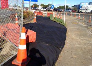 Erosion of an unstabilised area where utilities are being installed is minimised by covering soils to protect them from rain.