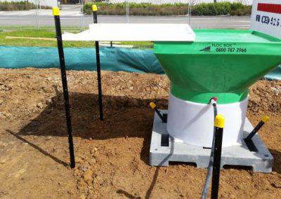 Portable rainfall activated dosing system for decanting earth bunds and sediment retention ponds.