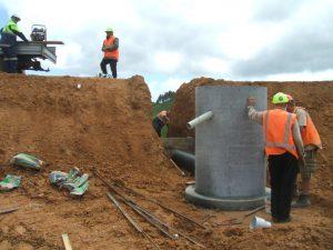 Installing the SRP outlet pipe and the anti-seep collars (Source: SouthernSkies).