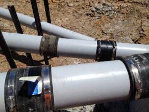 Steel strapping used to attach decant system to horizontal pipework.