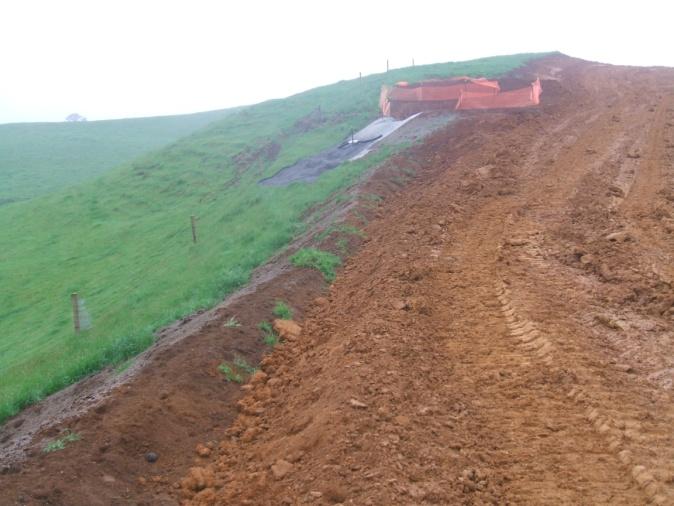 Decanting earth bund and diversion bund used to treat runoff during construction of a farm track.